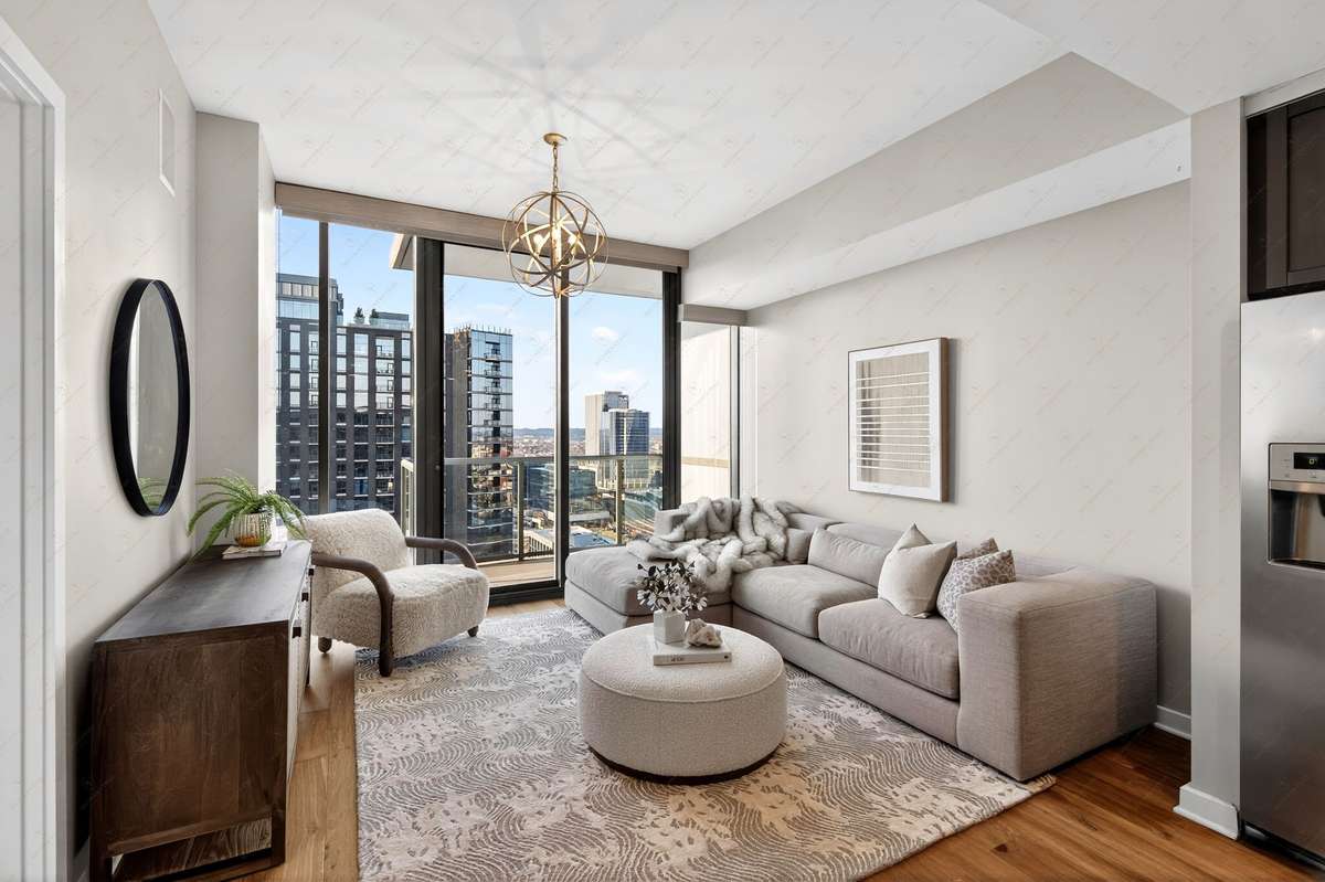 Views of the North Gulch, Nashville Yards and Downtown with see through glass balcony off  the living space