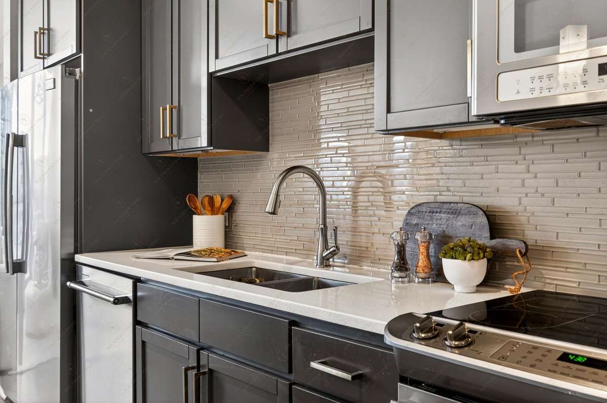 Beautiful cabinetry, quartz counter tops, pantry and plenty of storage throughout the kitchen space