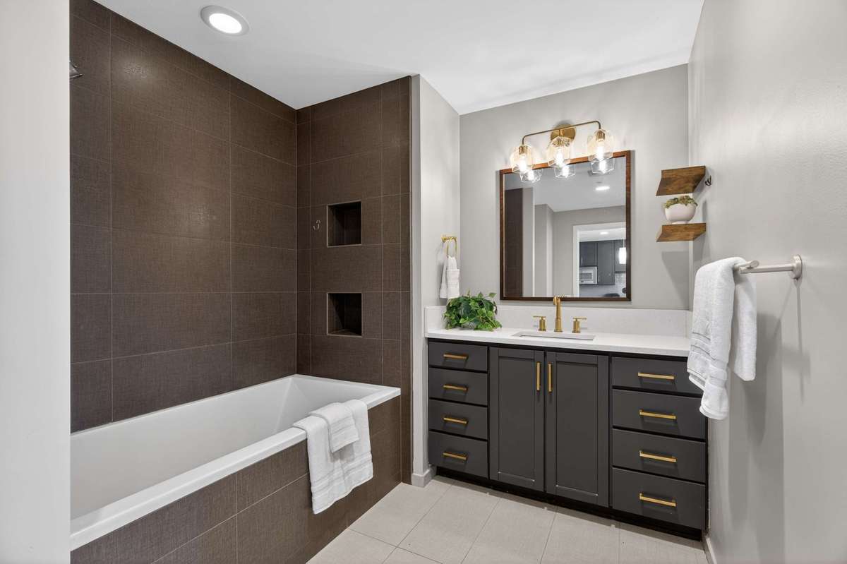 Large soaking tub, upgraded lighting and shelving make this very spacious primary bath with two separate entry ways a place to relax and/or get ready for your day