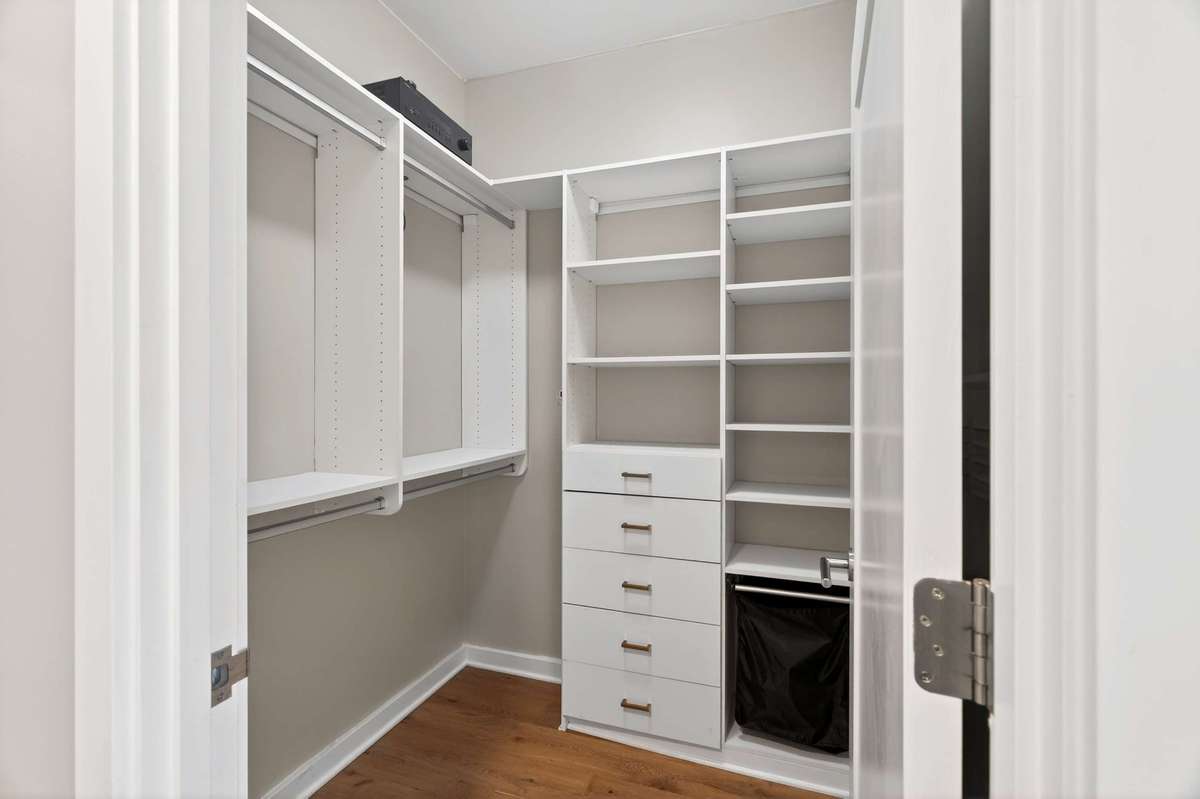 One of two closets as your enter the hall between bedroom and large bathroom with California Closet upgrade
