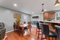This eat-in kitchen features a picturesque fireplace.
