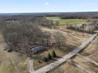 Drone footage of the land and home from the road front.