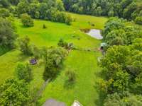 View of back yard and rear pasture with pond.