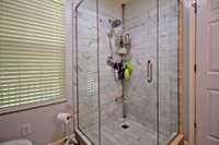 Owner's bath with separate glass shower.