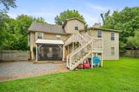 View of the rear of the house, showcasing the deck and covered entertainment area.