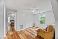 Second floor living area with access to more bedrooms and a bathroom.