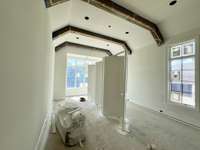 Primary Bedroom with wood beam detail Photo taken: 6/22/25