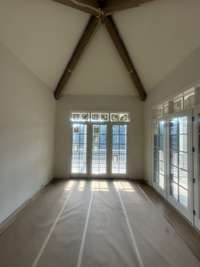 Dining Room off of Kitchen with vaulted ceiling and stained beams Photo taken: 7/2/25