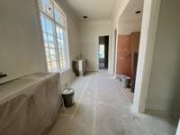 Main Level Primary Spa-like Bath with Double vanities, Oversized Shower, Separate Soaking Tub, walk-in Linen Closet and Dual Wardrobe Closet. Photo taken: 6/22/25