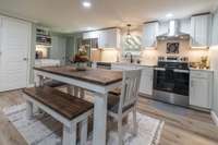 The large kitchen has a nitch for your coffee, stainless appliances and Quartzite countertops.