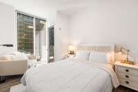 The guest bedroom is equally spacious with floor to ceiling glass and sets opposite the primary bedroom.