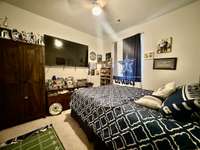 Main level Bedroom/Office/Hobby Room has carpet upgraded ceiling fan and 57 in TV/bracket conveys