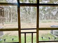 All you see are TREES while you enjoy relaxing on your screened patio