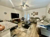 Townhouse is open floor plan that flows throughout the home. 72 in TV/bracket in Living Room conveys;  Built in 2023-one owner;