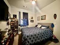 Main level bedroom with carpet, ceiling fan and extra large closet; 57 inch TV/bracket conveys