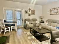 Living Room overlooking screened patio and backyard with private treeline
