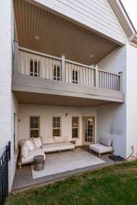 Side view of upstairs balcony and main floor courtyard patio.