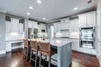 Gormet Kitchen complete with chef's desk, double ovens, gas cooktop, new island with quartz countertop and plenty of cabinet space.