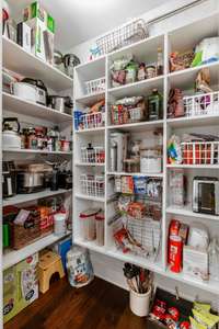 Walk-in Pantry with custom wood shelving.