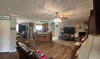large open concept living, dining & kitchen with an entryway closet!