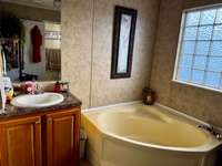 split dual vanities in the primary bath with a soaker tub and a separate shower!