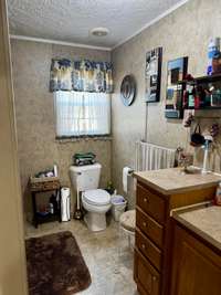 hall bath with large vanity and shower/tub combo