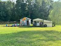 chicken coop on the left/ she shed on the right with a leanto for keeping your lawnmower out of the elements