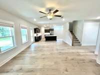 Great room standing at "TV wall" looking back towards kitchen. How many people can you invite to the party? Stock photo