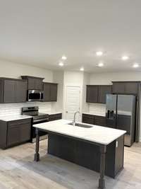 Gorgeous Graphite-stained cabinets with white quartz/grey veining countertops. Stock photo