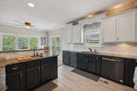 Ample storage space is available in this kitchen, featuring an extra sink that is always a must when more than one is sharing the same space..
