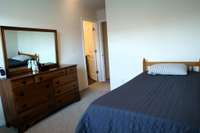 The primary suite w/ a spacious 12x13 layout designed for relaxation. This serene sanctuary features an ensuite bathroom complete with a convenient tub/shower combo, providing both style and functionality.