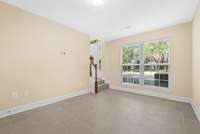 Another view of the bonus room. This photo shows the front entry of the home with garage entry door to your back.  Perfect space for your pets to relax while you are at work.