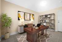 From the garage entry door, you enter an open space that is perfect for an office, bonus room, or movie room.  Photo is virtually staged.