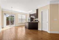 There is a half bathroom right off the kitchen. Pictured here you see the sliding glass door that leads out to a large deck perfect for entertaining.