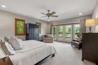 Primary bedroom with atrium doors leading out to the 2nd floor balcony