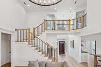 Upgraded Staircase with Wrought-Iron Railings & Hardwood Flooring