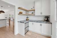 Large Walk-In Pantry with Custom Cabinetry, Beverage Refrigerator & Mitered-Edge Quartzite Countertops
