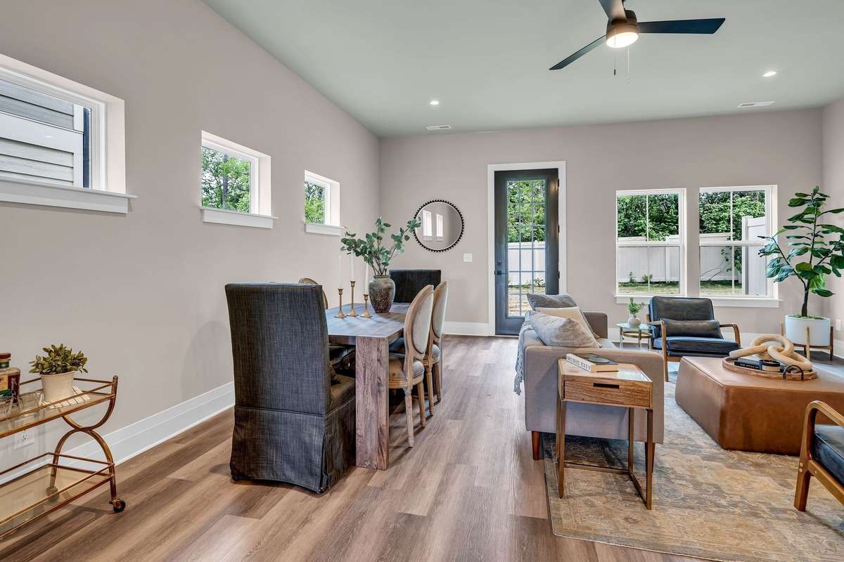 Spacious Living/Dining Area with 10 foot ceilings and 8 foot doors leading into a backyard which can be fenced.