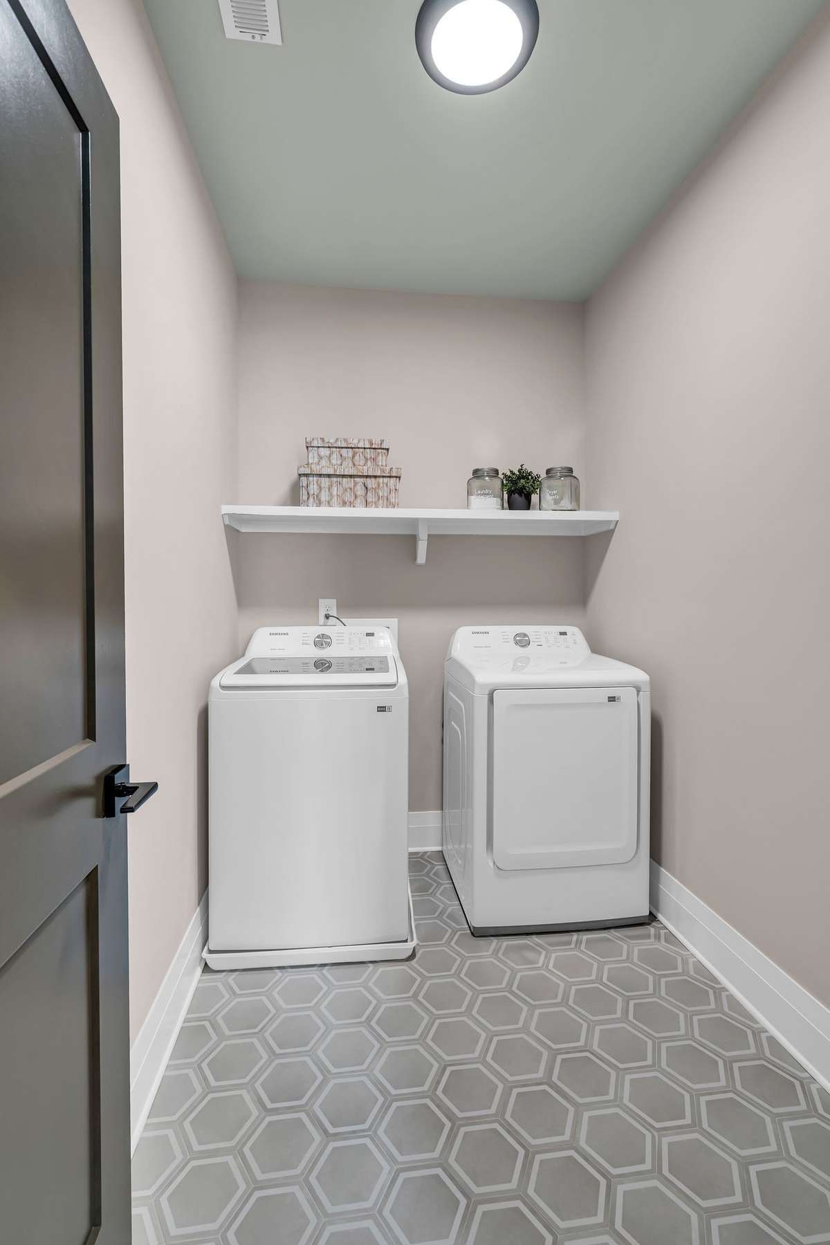 Large Laundry Room with Custom Tile Floors and Shelving.  Washer and Dryer Included