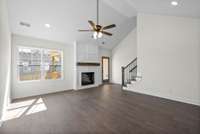 Large living room. The stairs are tucked away in the corner - leads to huge bonus room or second primary with walk in closet and full bath upstairs.