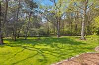 What a great view! Backyard extends into the wooded area.