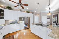 Virtually Staged - The wood on the cabinets are beautiful but if you prefer a white kitchen this photo shows how they would look if painted white.