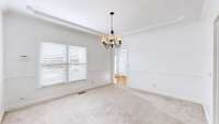 Dining room featuring a tray ceiling and crown molding that enhances the space.