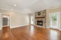 Spacious living room with a stone fireplace as the focal point. Cozy yet open, ideal for gatherings, quiet nights, or creating lasting memories.