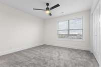 Spacious secondary bedroom filled with natural light and neutral tones. Ideal for guests, kids, or a home office.