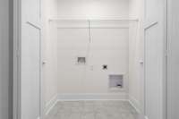 Designated laundry area tucked away behind double doors. Practical and ready for your washer and dryer setup.