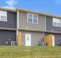 Back entry opens to a grassy area with room to relax or enjoy a little fresh air right outside your door.