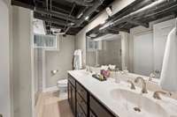 The basement bathroom has dual vanities and a walk-in shower.