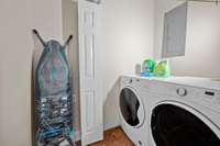 The laundry room is conveniently located next to the kitchen.