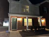 Capturing a photo of this end unit in the evening - showing plenty of outdoor lighting giving you that additional sense of security. HOA includes lawn maintenance and insurance as well as community trash compactor.